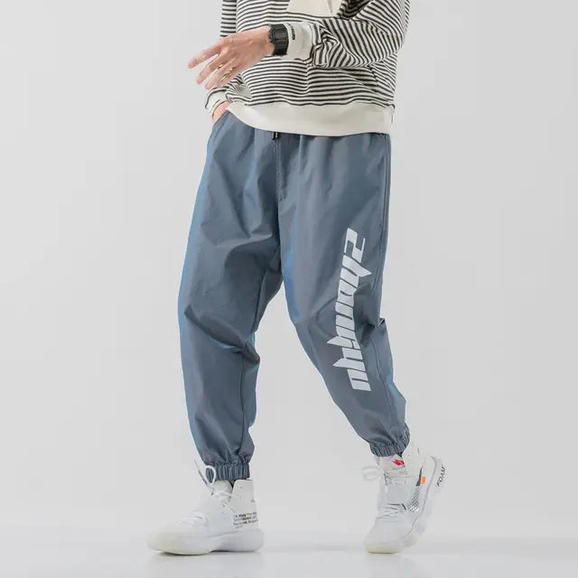 https://ae01.alicdn.com/kf/S71e9aac3be144f70963c8f888dcf6484K/Hip-Hop-Trendy-Men-Casual-Reflective-Sweatpants-Spring-Autumn-Korean-Streetwear-Fashion-New-Baggy-Elastic-Waist.jpg_640x640.jpg