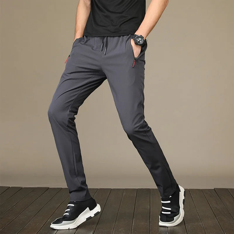 https://ae01.alicdn.com/kf/S0dbe34540eb84bb08f70f9316bdefca0y/Men-S-Zipper-Dry-Quick-Leisure-Pants-Mid-Waist-Casual-Versatile-Trend-Slim-Sports-Loose-Pants.jpg