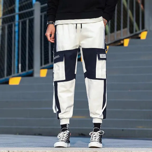 https://ae01.alicdn.com/kf/H672cf9946a5f44e69ab1d01dcc259262X/Ribbons-Harem-Joggers-Men-Cargo-Pants-Streetwear-2023-Hip-Hop-Casual-Pockets-Track-Pants-Male-Harajuku.jpg_640x640.jpg
