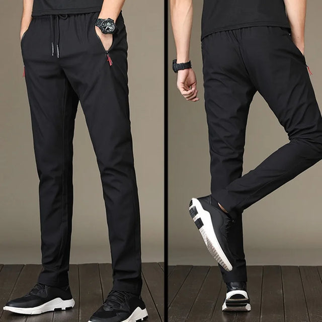 https://ae01.alicdn.com/kf/S891c0cf258cc485bb74a13194afbbe7d2/Men-S-Zipper-Dry-Quick-Leisure-Pants-Mid-Waist-Casual-Versatile-Trend-Slim-Sports-Loose-Pants.jpg