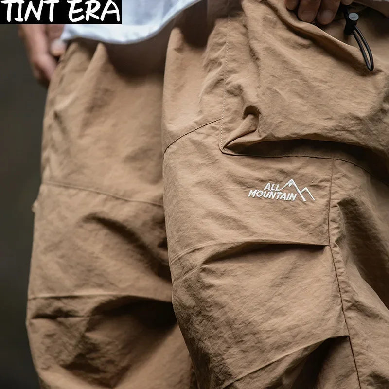 https://ae01.alicdn.com/kf/S85a86bcb94f8490191b4dee7a4230438Q/TINT-ERA-Parachute-Cargo-Pants-Men-Oversize-Outdoor-Casual-Trousers-Male-Waterproof-Pants-Man-Japanese-Streetwear.jpg