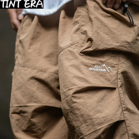 https://ae01.alicdn.com/kf/S85a86bcb94f8490191b4dee7a4230438Q/TINT-ERA-Parachute-Cargo-Pants-Men-Oversize-Outdoor-Casual-Trousers-Male-Waterproof-Pants-Man-Japanese-Streetwear.jpg